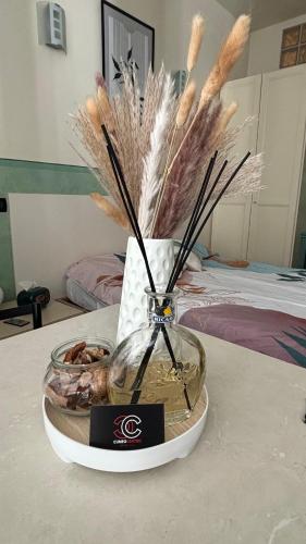 a vase with feathers in it on a table at Cuneo Centro Affittacamere in Cuneo