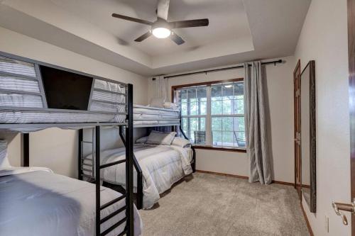 a bedroom with two bunk beds and a window at Rural 6 bedroom cabin - With a Hot Tub! in Exeter