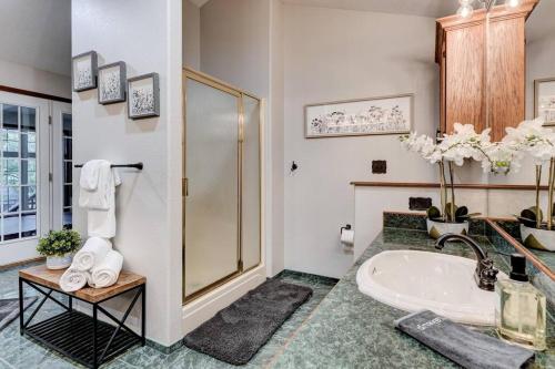 a bathroom with a sink and a shower at Rural 6 bedroom cabin - With a Hot Tub! in Exeter