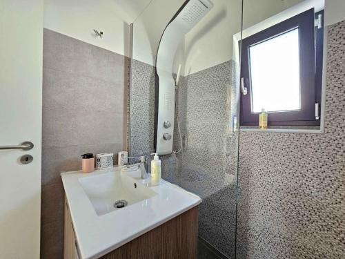 a bathroom with a sink and a shower at House of Belverde with Pool in Amora