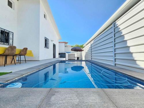 a swimming pool in front of a house at House of Belverde with Pool in Amora