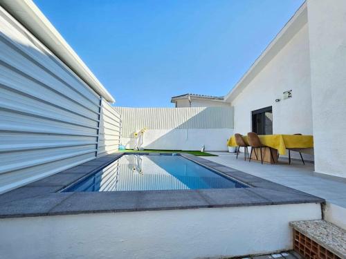 a swimming pool on the side of a house at House of Belverde with Pool in Amora