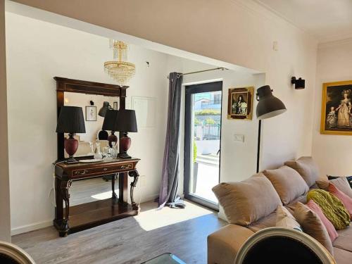 a living room with a couch and a table at House of Belverde with Pool in Amora