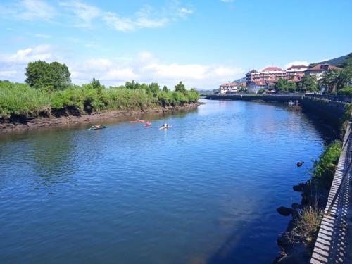 a river with several people kayaking on it at Vegalmar in Limpias