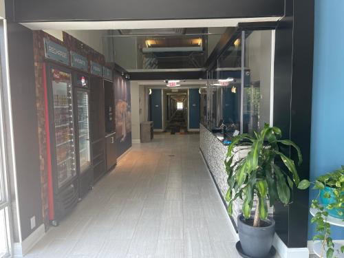 a hallway of a building with a potted plant at Wingate By Wyndham Columbia Fort Jackson in Columbia