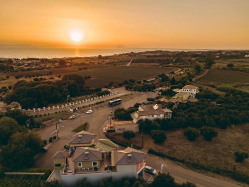 an aerial view of a house with the sunset in the background at Ananda Apartments in Kalakaíika