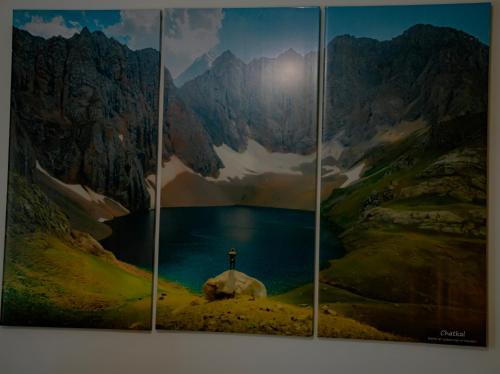 a painting of a mountain scene with a horse and a lake at Hotel Good Night in Jalal-Abad