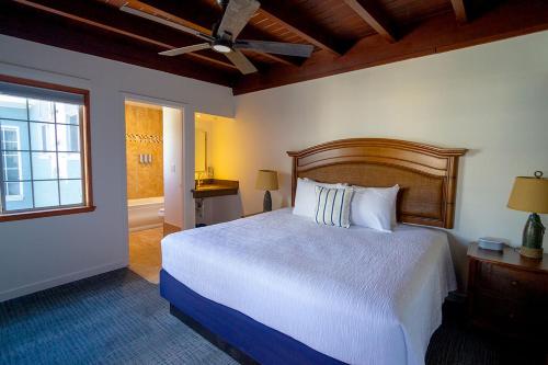 a bedroom with a large bed and a window at Edgewater Beach Inn in Santa Cruz
