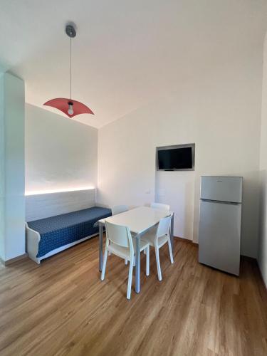 a room with a table and chairs and a couch at Casa Campanella Resort in Capoliveri