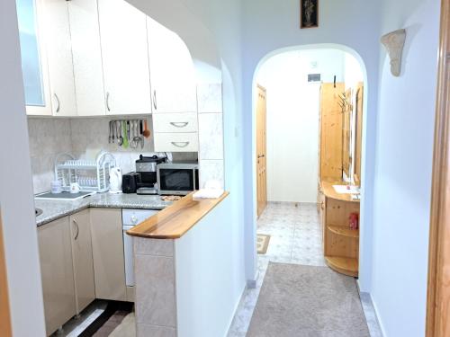 a kitchen with white cabinets and a counter top at Apartment Beti in Devin