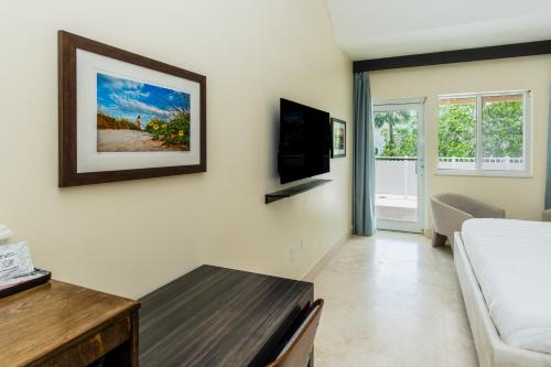 a living room with a couch and a table at The Link Hotel South Beach in Miami Beach