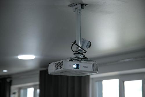 a projector hanging from the ceiling of a room at Hotel Good Night in Jalal-Abad
