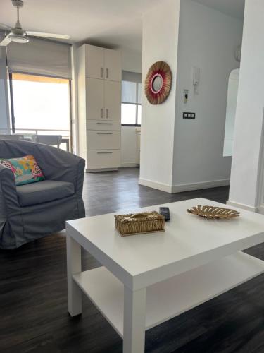a living room with a white table and a couch at Vista Bahia in Arrecife