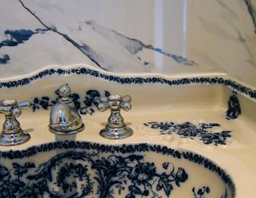 a blue and white sink with two faucets at Domaine du cloitre in Pléneuf-Val-André