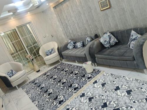 a living room with a couch and a rug at ميراج in Cairo