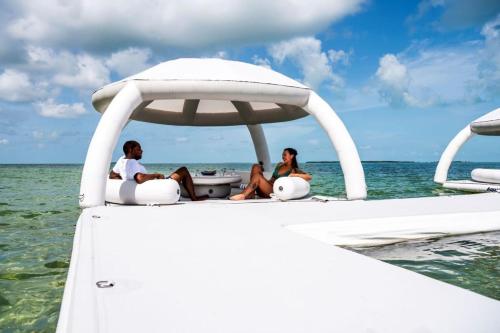 two people sitting on the back of a boat in the water at Endless Summer 42 in Key Largo