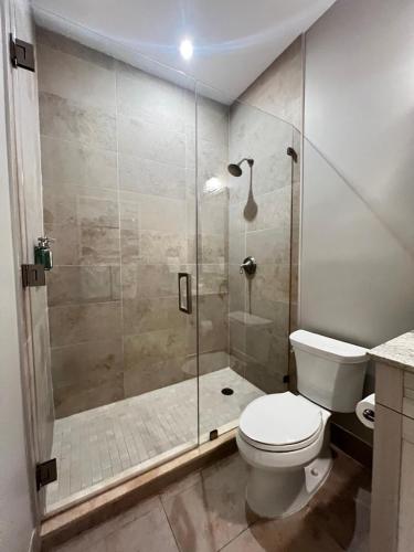 a bathroom with a toilet and a glass shower at Endless Summer 42 in Key Largo