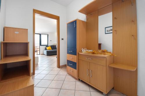a room with wooden cabinets and a living room at Hiša Ivančič in Šared