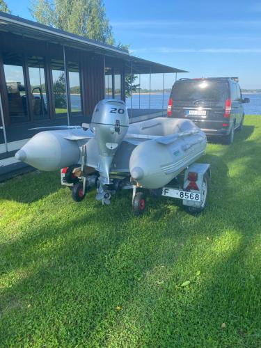 a plane parked in the grass next to a van at Daugava in Aizkraukle