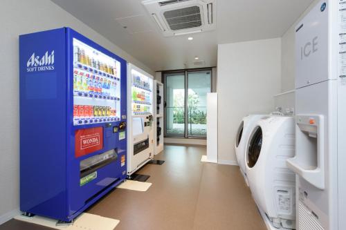 a hospital room with a washing machine and a dryer at Futakotamagawa Excel Hotel Tokyu in Tokyo