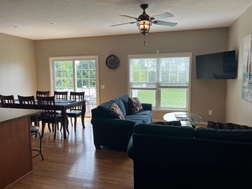 a living room with a couch and a dining room at Three Schooners Landing Condo 2 in Sodus Point
