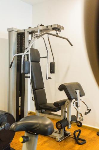 a gym with a treadmill and two chairs at Accra Luxury Apartments at Clifton Place in East Legon