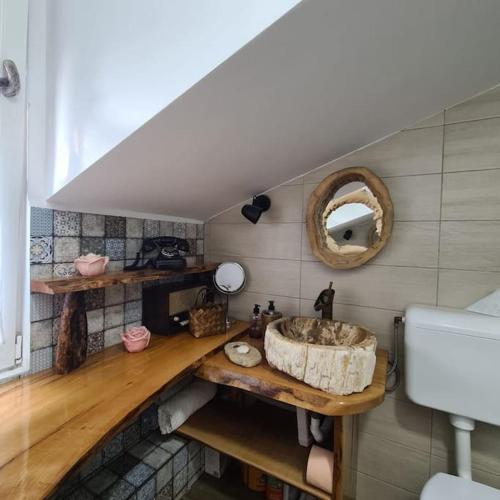a bathroom with a sink and a mirror at Mansarda boema, gradina de basm in Bucharest