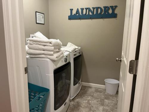 a laundry room with a washing machine and a tv at Etta Belle Condo 1 in Sodus Point