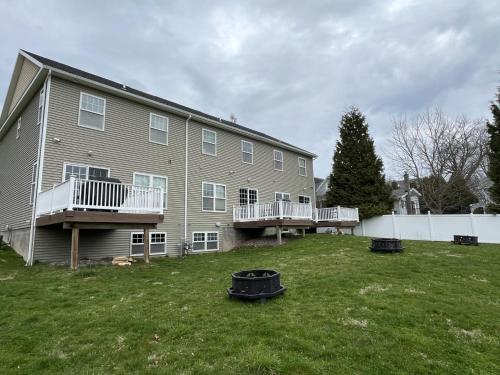 a large house with two balconies and a yard at Etta Belle Condo 1 in Sodus Point