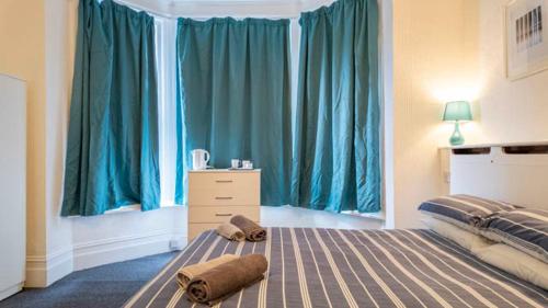 a bedroom with a bed with two towels on it at Pebbles guest house room 11 in Southampton