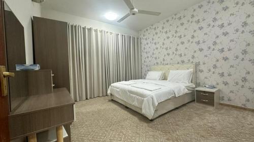 Ένα ή περισσότερα κρεβάτια σε δωμάτιο στο Alyaqoot Apartments
