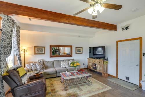 a living room with a couch and a tv at Walk to Water Camano Home with Ocean-View Deck in Camano