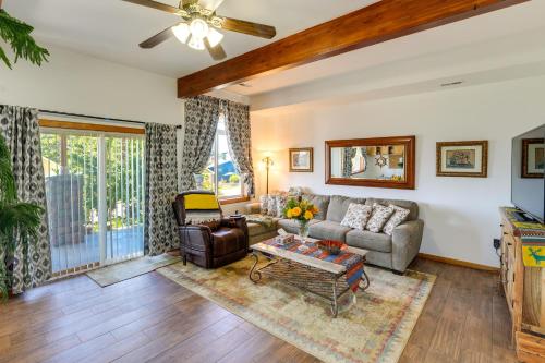 a living room with a couch and a table at Walk to Water Camano Home with Ocean-View Deck in Camano