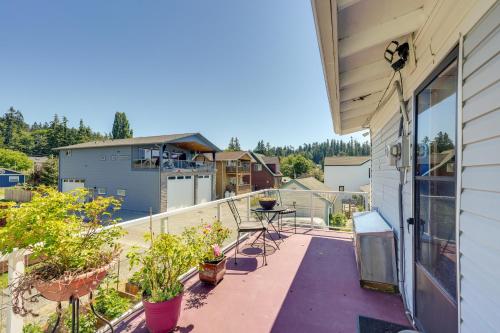 a balcony with potted plants and a table at Walk to Water Camano Home with Ocean-View Deck in Camano