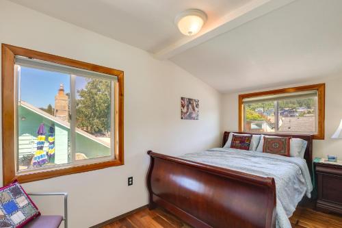 a bedroom with a bed and a large window at Walk to Water Camano Home with Ocean-View Deck in Camano