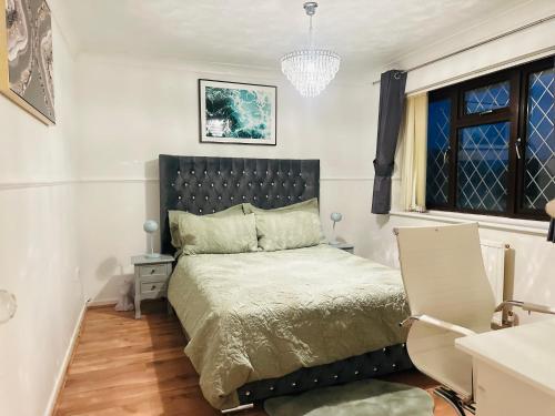 a bedroom with a bed with a black headboard at Home away from home in Swindon