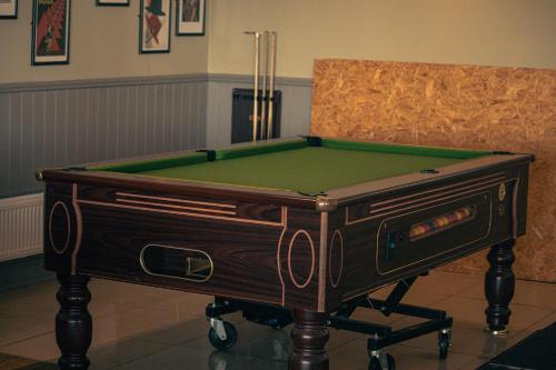 a pool table in front of a chair at 23 Chestnut Grove in Kirkcolm
