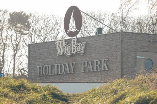 a sign for a holiday park on the side of a building at 23 Chestnut Grove in Kirkcolm