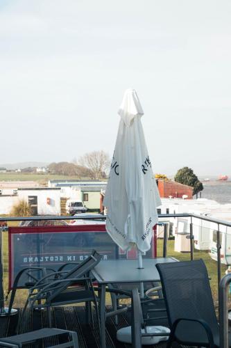 a white umbrella sitting on top of a table at 23 Chestnut Grove in Kirkcolm