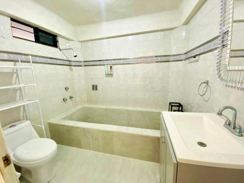 a bathroom with a tub and a toilet and a sink at Casa Independencia in Santa Julia