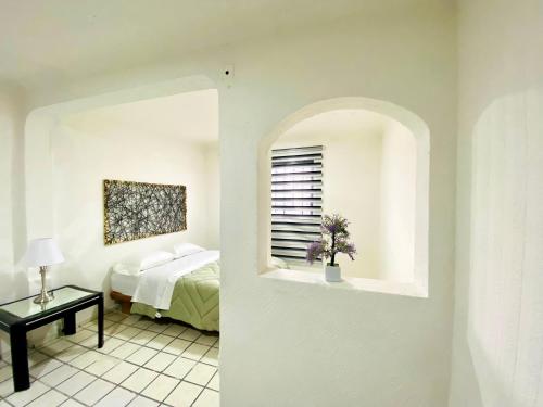 a bedroom with a bed and a window and a table at Casa Independencia in Santa Julia