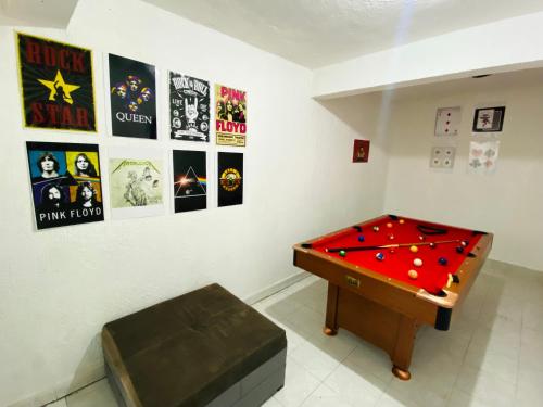 a room with a pool table and posters on the wall at Casa Independencia in Santa Julia