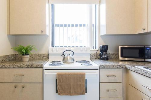 a kitchen with a stove and a tea kettle on it at Studio in Pompano Beach two blocks from the Ocean in Pompano Beach