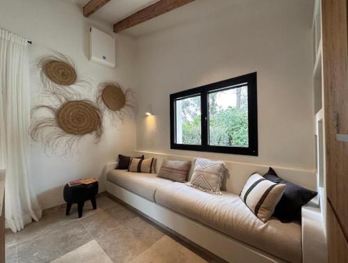a living room with a couch and a window at Ca Jardi, Luxury Ibiza-Style villa with private pool, Javea in Jávea