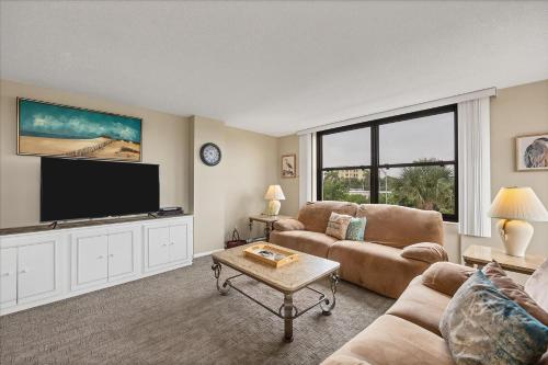 a living room with a large flat screen tv at 6415 Midnight Pass #304 in Siesta Key