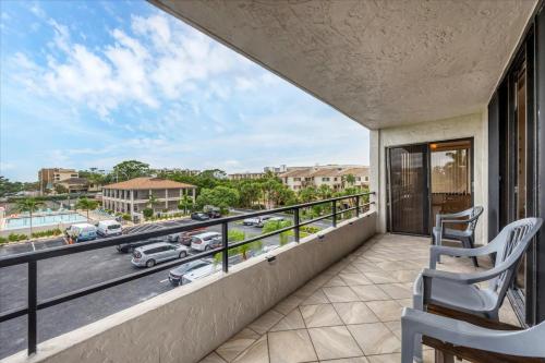 a balcony with chairs and a view of a street at 6415 Midnight Pass #304 in Siesta Key