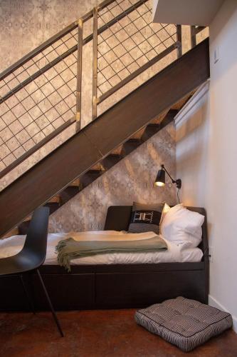 a loft bed with a desk and a chair in a room at Viaduct Loft at Kestrel Hotel in Philadelphia