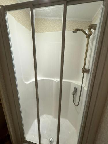 a shower with a glass door in a bathroom at Millfields Holiday Park - The Balmoral - Coastal Caravan Breaks in Ingoldmells