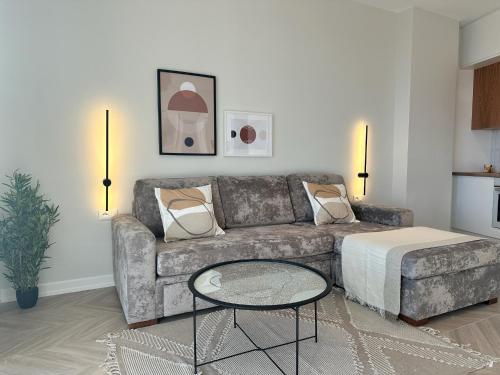 a living room with a couch and a coffee table at Veronica Apartment in Sarandë