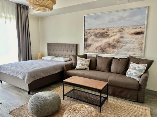 a living room with a couch and a bed at Aisa 39 in Pärnu